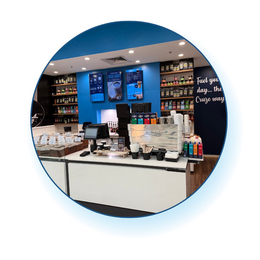 Cafe with a counter, shelves, and coffee beans.