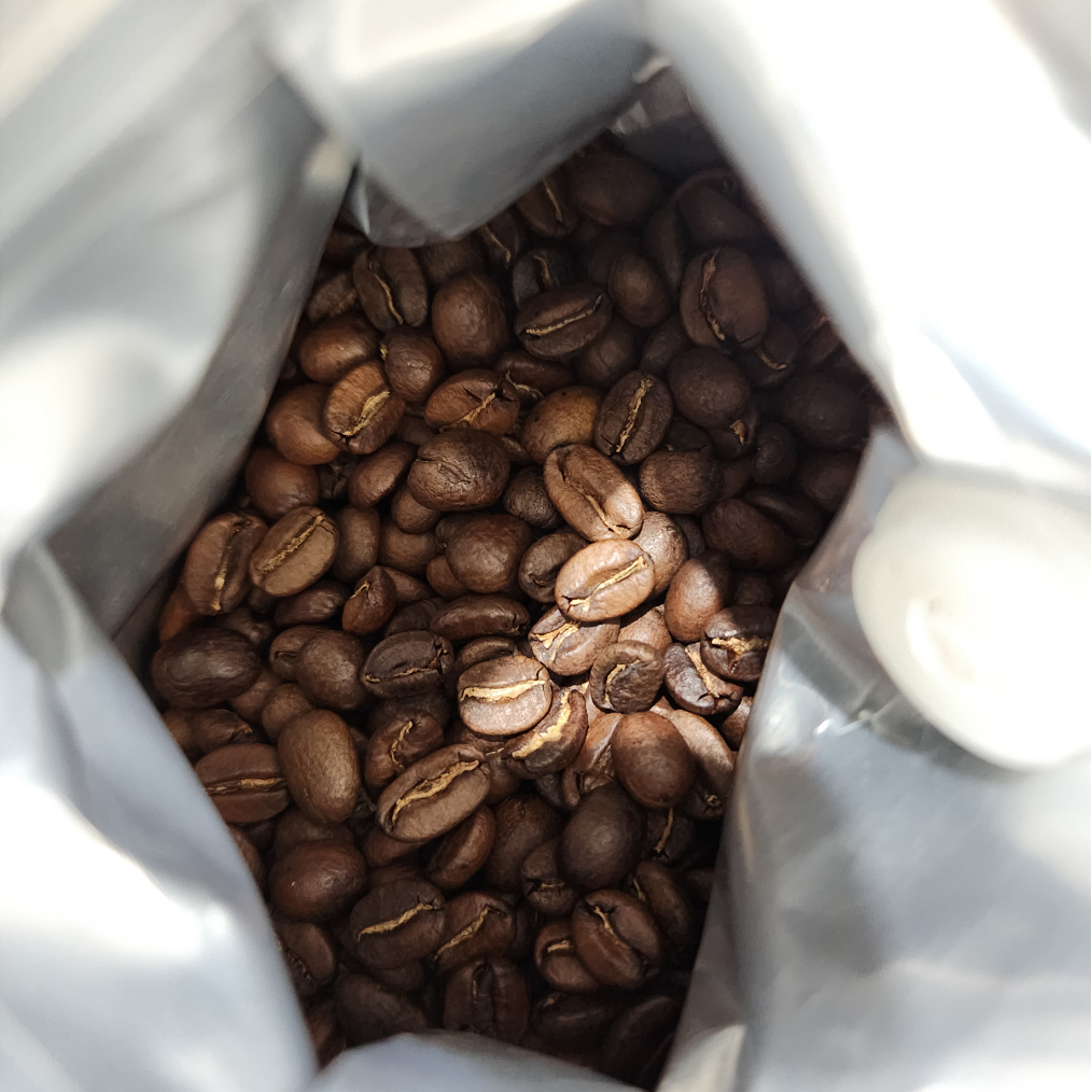 Open bag of coffee beans with a close-up view